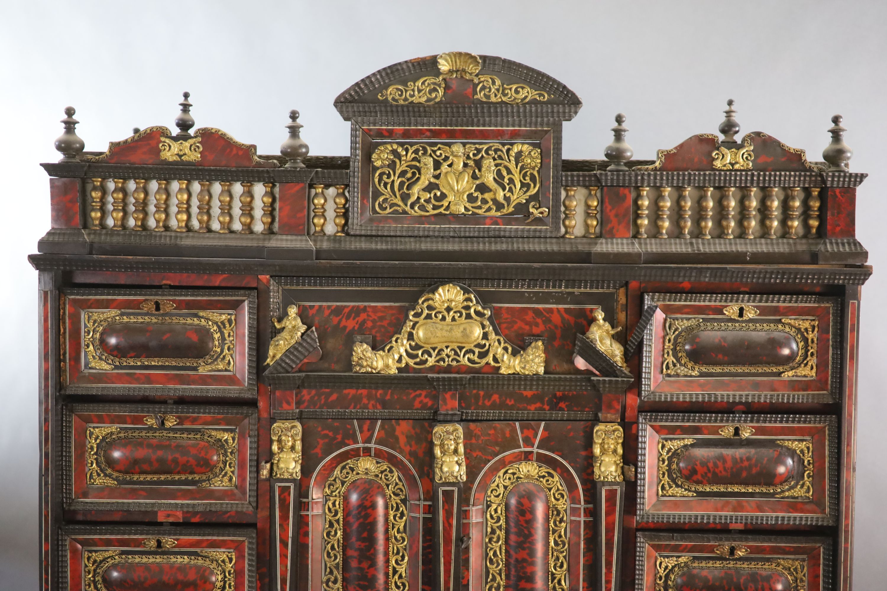 A late 17th century Portuguese ormolu mounted ebony and red tortoiseshell cabinet on stand, W.124cm D.46cm H.187cm